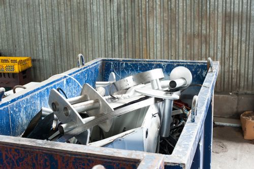 dumpster full of metal and electronic equipment